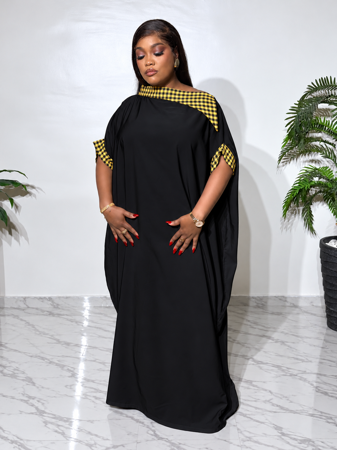 Elegant Black boubou with black and yellow checkered accents, featuring a flowing silhouette, statement cape sleeves, and a luxurious finish.