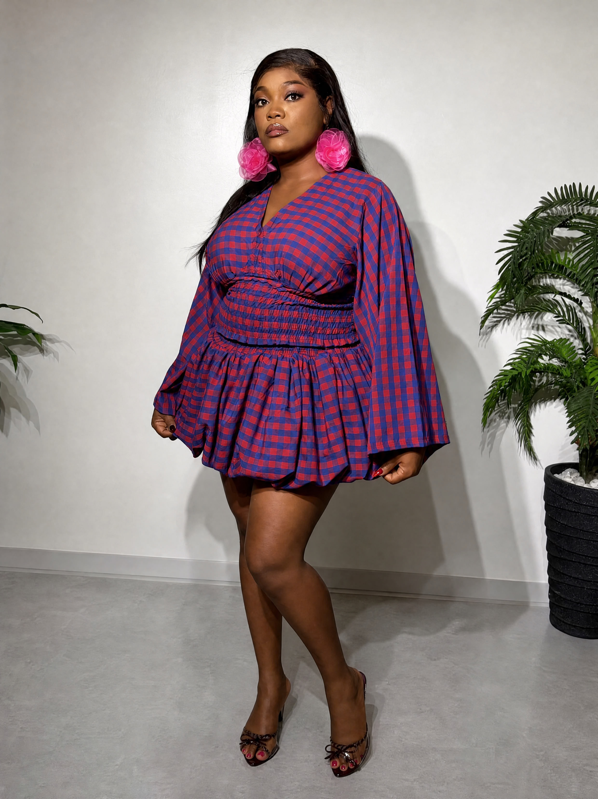 A fashionable two-piece women's outfit featuring a smocked-waist top, statement bell sleeves, and a stylish bubble skirt for a chic and feminine look.