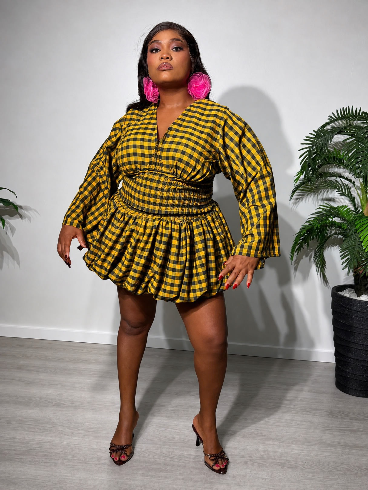 A fashionable two-piece women's outfit featuring a smocked-waist top, statement bell sleeves, and a stylish bubble skirt for a chic and feminine look.