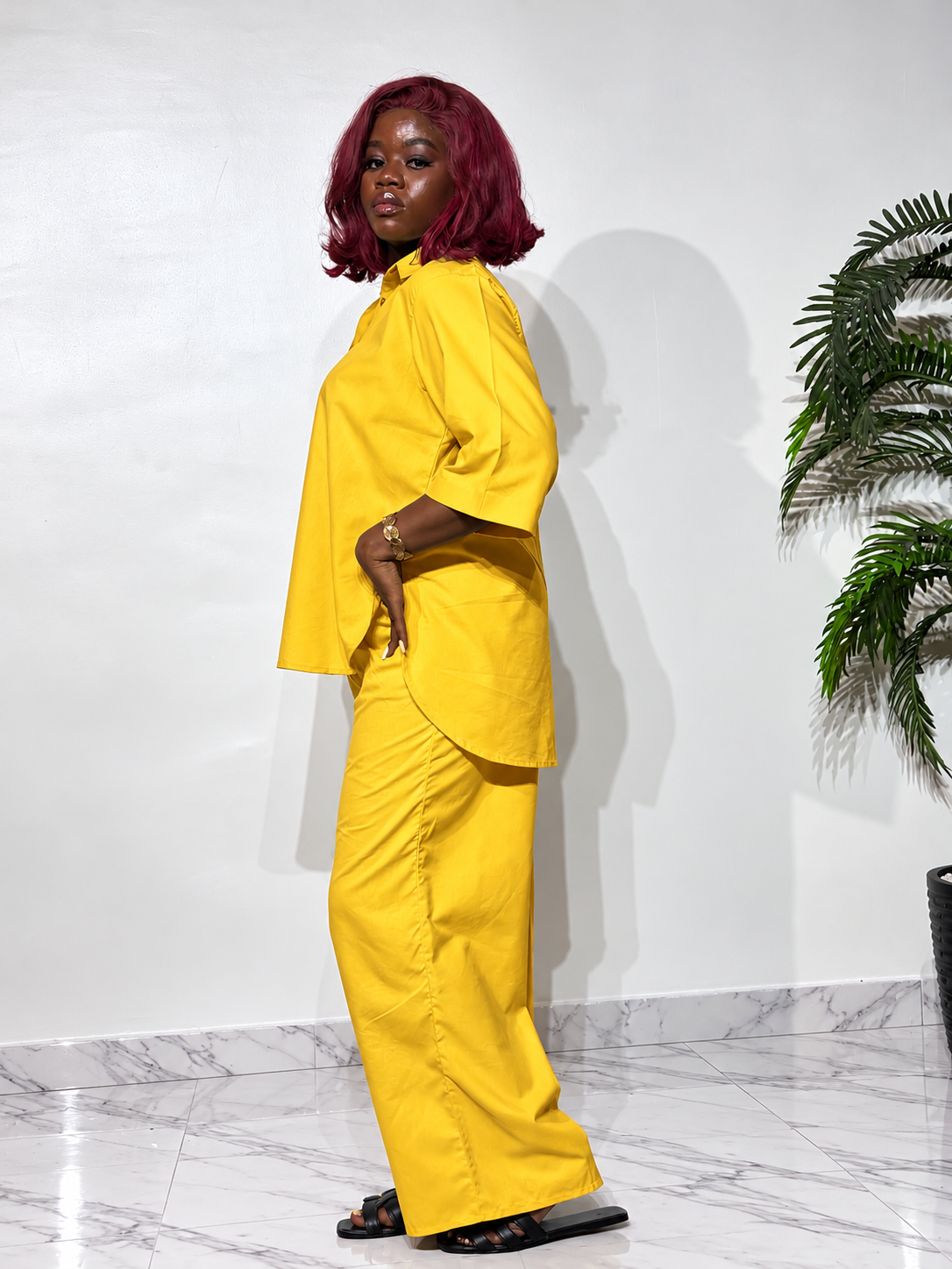 Asymmetry Two-Piece Set , featuring an oversized button down shirt with a longer back hem and flowing wide-leg trousers. 