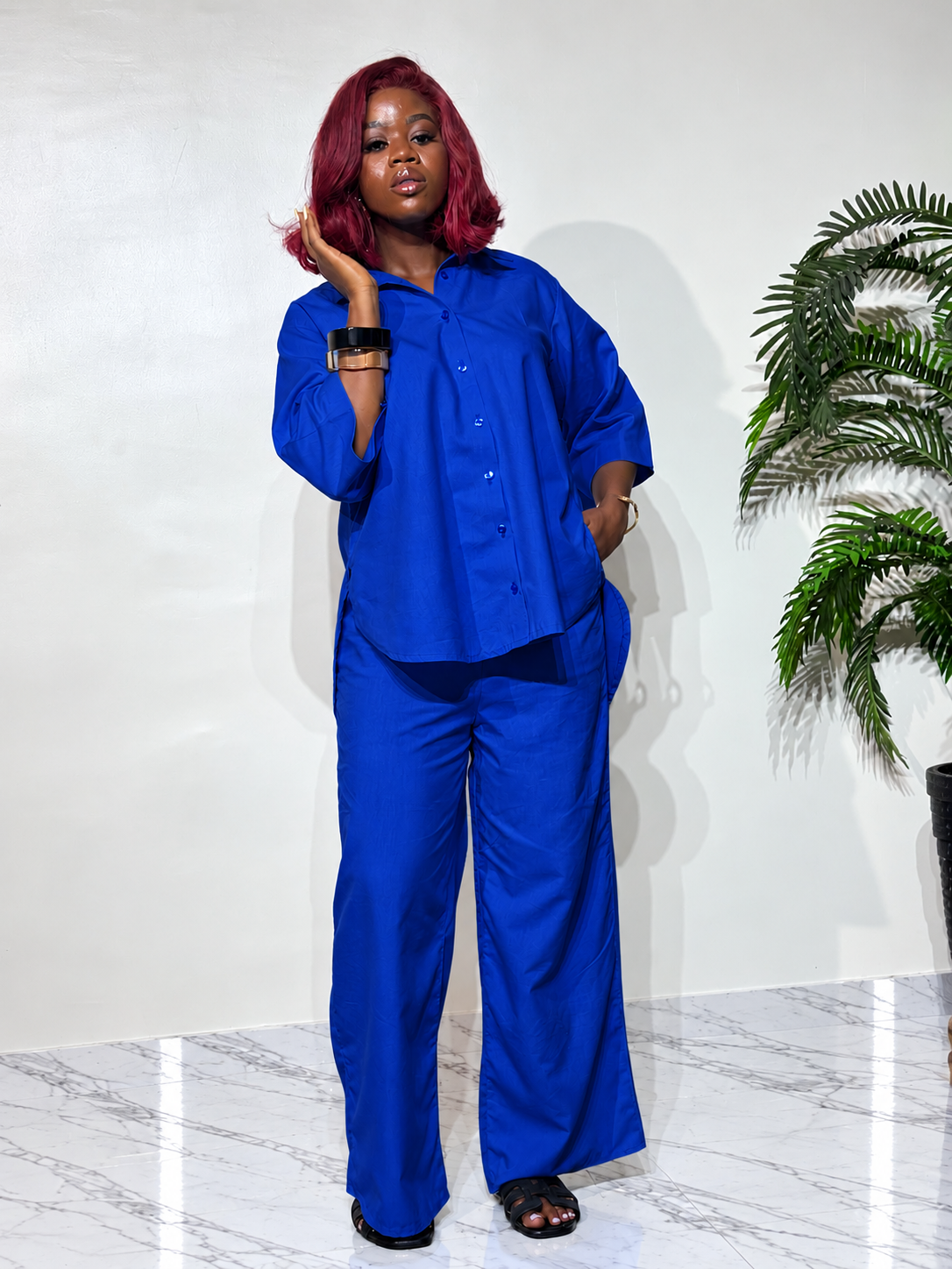 Asymmetry Two-Piece Set , featuring an oversized button down shirt with a longer back hem and flowing wide-leg trousers. 