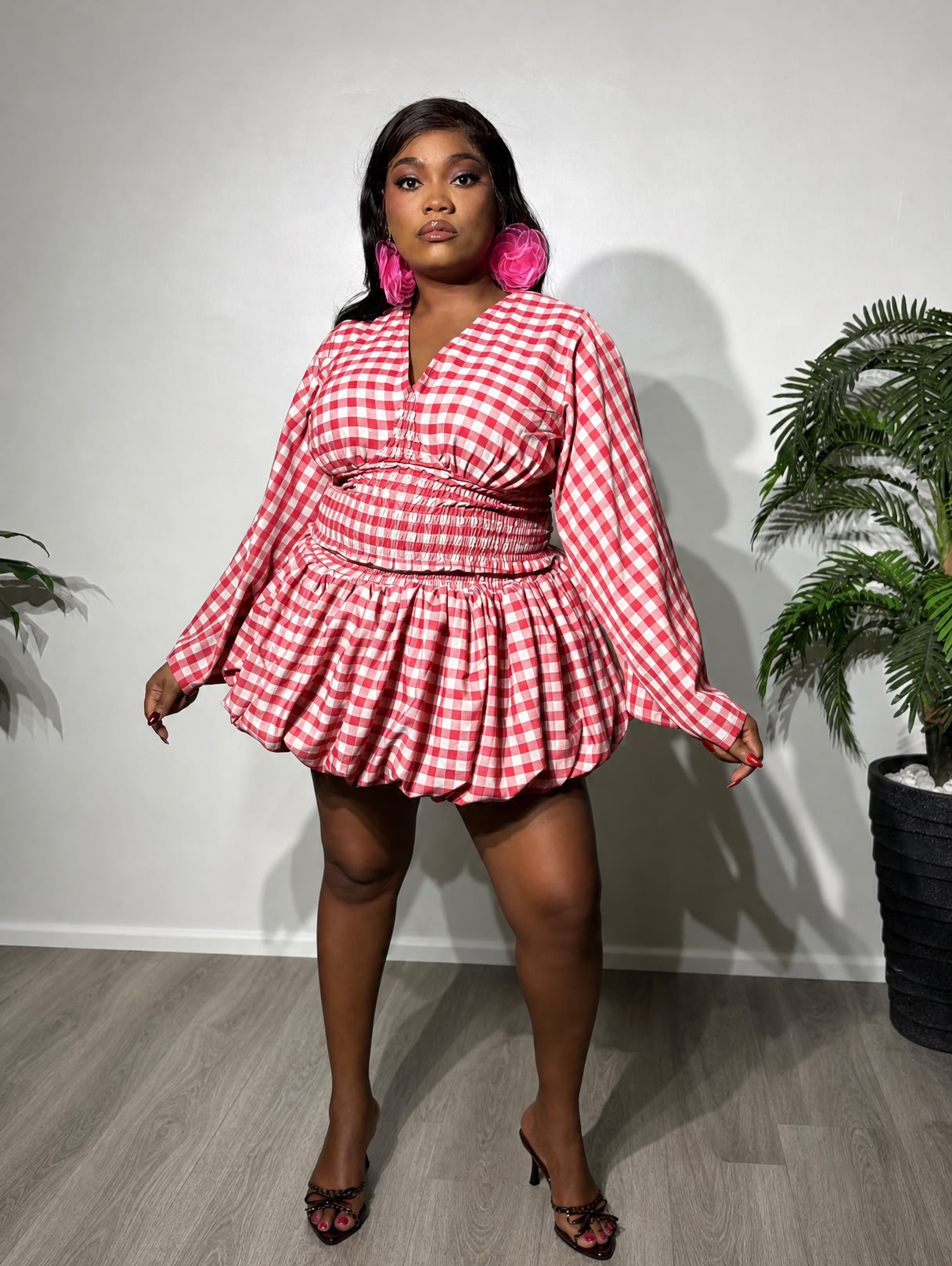 A fashionable two-piece women's outfit featuring a smocked-waist top, statement bell sleeves, and a stylish bubble skirt for a chic and feminine look.